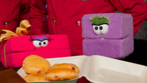 Mel and Carl meet Chip and Bernie for the first time in a festive North Pole workshop during a Christmas puppet adventure.